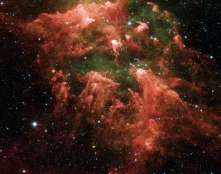 Spitzer-Weltraumteleskop-Falschfarbenbild der Südpfeilerregion der sternbildenden Region namens Carina-Nebel. Sternembryonen (gelb oder weiß) in fingerartigen Säulen aus dickem Staub (rosa). Heiße Gase.